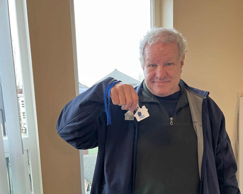 man holds his new keys